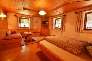 a bedroom with a bed and a couch in a room at Kartnall´s Alm in Neustift im Stubaital