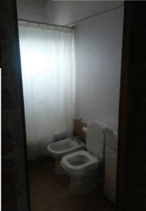 a small bathroom with a toilet and a sink at Cabaña San Pablo in San Salvador de Jujuy