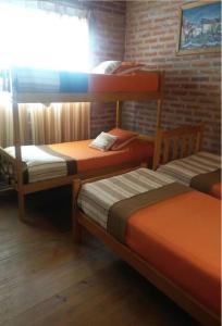 a room with two bunk beds and a window at Cabaña San Pablo in San Salvador de Jujuy