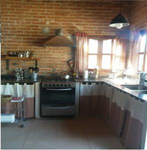 a kitchen with a stove and a sink at Cabaña San Pablo in San Salvador de Jujuy