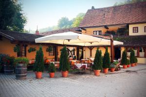 a restaurant with tables and umbrellas and potted plants at Guest House pri Vodniku in Ljubljana
