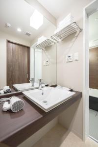 a bathroom with a large sink and a mirror at Number 6 Nijo in Kyoto