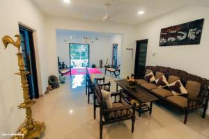 a living room with a couch and a table at Thomasz Lodge in Kandy