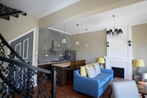 a living room with a blue chair and a fireplace at Luxe Wilderness in Nuwara Eliya