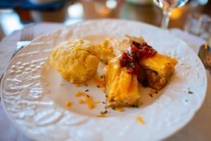 a white plate with some food on a table at Canyon Villa Bed & Breakfast Inn of Sedona in Sedona