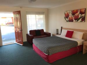 
A bed or beds in a room at Beachcomber Motel & Apartments
