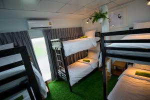 a group of bunk beds in a room at Victory Park Hostel in Bangkok +43 photos