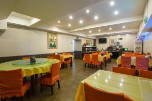 a dining room with tables and chairs with yellow table cloth at Jinjiang Inn Beijing Hepingmen in Beijing