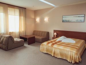 En eller flere senge i et værelse på Hotel Diana