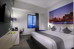 Postel nebo postele na pokoji v ubytování Hotel Neo+ Kebayoran Jakarta
