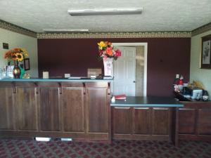 a kitchen with a large mirror and a wooden table at Stonebrook Inn in Counce