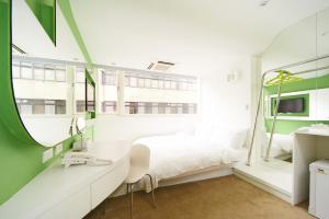 a bedroom with a white bed and a mirror at Forever Inn in Taipei