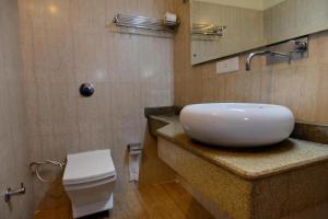 a bathroom with a sink and a toilet at Hotel Diamond Inn in Chandīgarh +8 photos