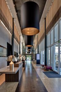 a lobby of a building with a large chandelier at Hotel Sempachersee in Nottwil