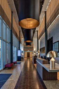 a lobby of a building with a large ceiling at Hotel Sempachersee in Nottwil