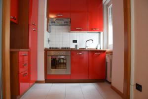 a kitchen with red cabinets and a sink at Residence Sole in Trieste