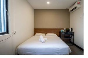 1 dormitorio con 1 cama con 2 toallas en MAX Hotel Subang Jaya, en Subang Jaya