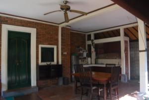a living room with a table and a green door at Wikarmas Villa Sanur in Sanur