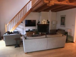 a living room with a couch and a staircase at Celine 9, Champery in Champéry