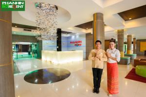 two people standing in the lobby of a building at Phanhin Regent 304 -SHA Extra Plus in Si Maha Phot