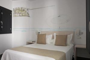 Postel nebo postele na pokoji v ubytování La Pasajera Hostal Boutique