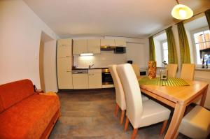 a kitchen and dining room with a table and a couch at Bauernhof Gfraser in Serfaus