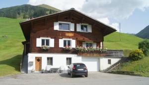 a house with a car parked in front of it at Studio Schija in Sankt Antönien