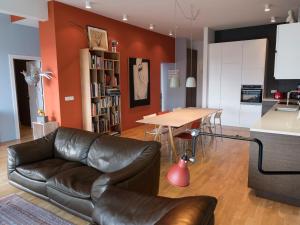 a living room with a leather couch and a table at Reykjavík Central Apartments in Reykjavík