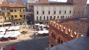 an aerial view of a city square with white umbrellas at Hotel Aurora in Verona