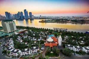 an aerial view of a city with a river and buildings at Marbella Resort in Sharjah