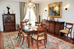 a dining room with a wooden table and chairs at OurMadeira - Villa Luzia, luxury in Funchal