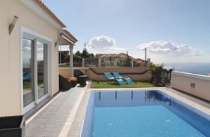 a swimming pool in the backyard of a house at OurMadeira - Villa Dilis, informal in Calheta