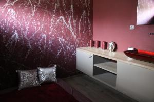 a bathroom with a sink and a red wall at Blue House Relax in Velké Popovice