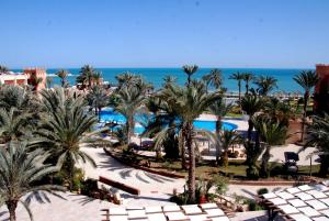 a view of a resort with palm trees and the ocean at Vincci Safira Palms in Sangho