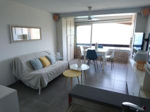 a living room with a couch and a table at Portvendres Sea view in Port-Vendres