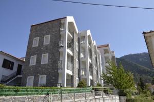 an apartment building with a mountain in the background at Kalavrita Luxurious Apartments in Kalavrita