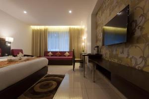 a hotel room with a bed and a couch at Hotel Udai Median in Udaipur
