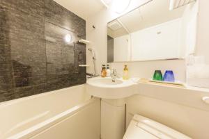 a white bathroom with a sink and a toilet at Kyoto Inn Gion The Second in Kyoto