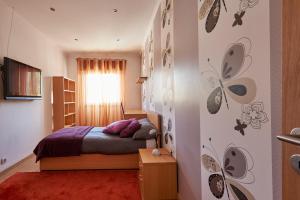 a bedroom with a bed and a wall with stickers at In Bed with Lisbon 4E in Amadora