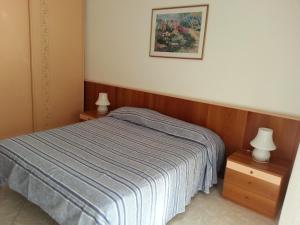 a bedroom with a bed and two night stands at Lago Residence in Desenzano del Garda +20 photos