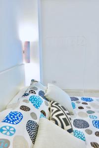 a bed with blue and white pillows on it at Villa Alba in Acitrezza