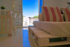 a couch sitting in a living room with a window at Villa Alba in Acitrezza