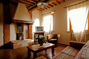 a living room with a couch and a fireplace at Borgo Fajani in Terricciola