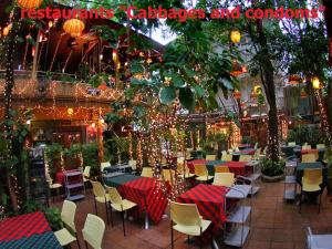a patio with tables and chairs and christmas lights at Tropical Garden Studio in Pattaya South