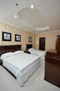 Postel nebo postele na pokoji v ubytování Hotel Formosa Daet