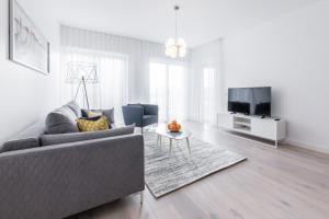 a living room with a couch and a tv at Tallinn Premium Apartments in Tallinn
