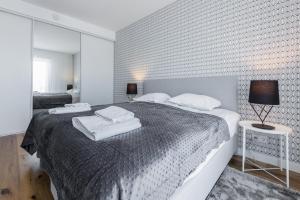 a bedroom with a bed with white towels on it at Tallinn Premium Apartments in Tallinn