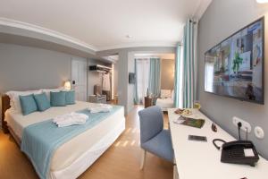 a hotel room with two beds and a television at Aenos Hotel in Argostoli