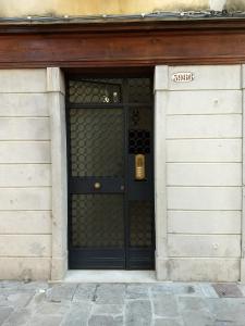 a black door with a sign on it in a building at Alloggi Alla Rivetta in Venice