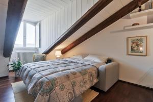 a bedroom with a large bed and a staircase at Appartamento Porta Susa 2 in Turin